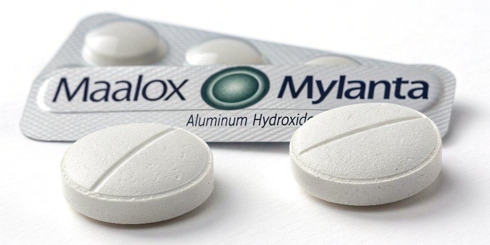 A close-up of a well-known brand of antacid tablets, like Maalox or Mylanta.
