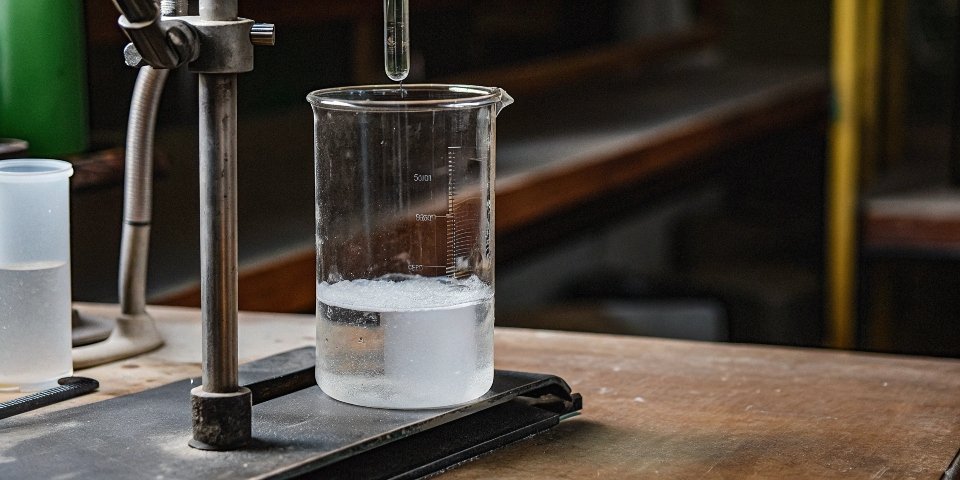 Why Aluminum Hydroxide Does Not Dissolve A lab beaker with a magnetic stirrer trying to dissolve white Al(OH)3 powder in water, resulting in a cloudy suspension