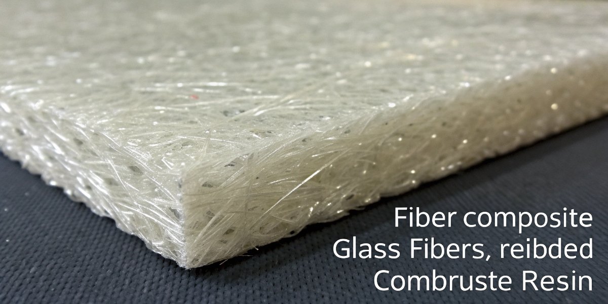 Glass Fibers in Combustible Resin A close-up view of a fiberglass composite material showing the glass fibers embedded in plastic resin.