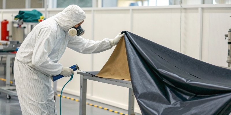 Coating Process for Functional Fabrics A diagram showing a fabric being coated with a solution containing FR and low-friction particles