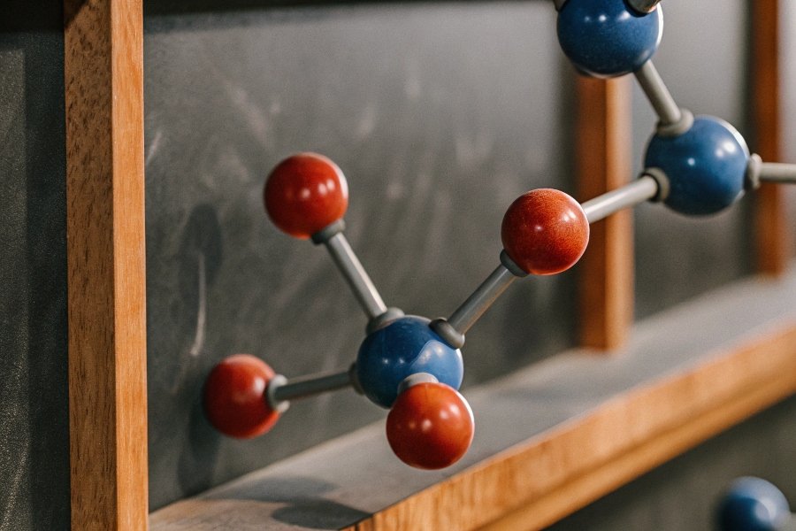 alt with keywords: A chemical diagram showing a basic antacid molecule neutralizing an acid molecule.