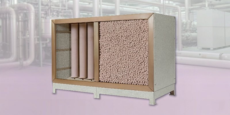 An industrial compressed air dryer system with a cutaway showing activated alumina inside
