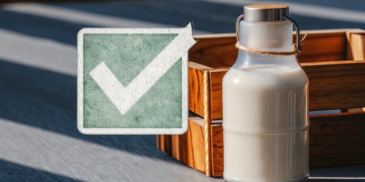A green checkmark next to a bottle of Milk of Magnesia indicating its safety