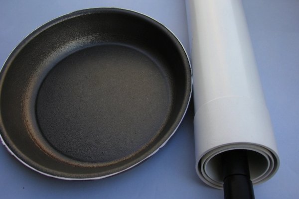 alt with keywords: A piece of Teflon (PTFE) cookware next to a PVC pipe to show examples of inherently non-flammable plastics