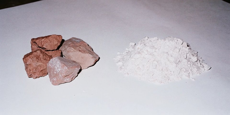 A before-and-after image showing reddish bauxite ore on one side and pure white aluminum hydroxide powder on the other