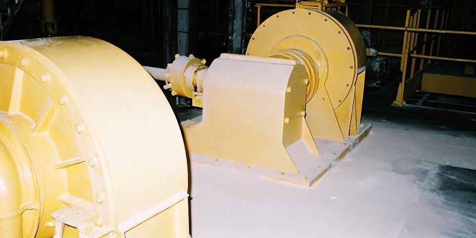 Industrial grinders crushing bauxite rock into a fine powder