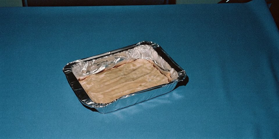 Foil and Acidic Food A lasagna in an aluminum foil pan, representing cooking with acidic foods.