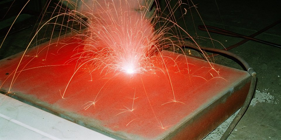 An intensely bright white light from a thermite reaction burning through a piece of metal