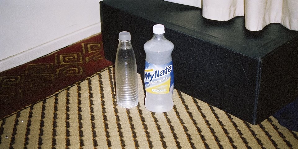 A box of Mylanta next to bottles of its separate active ingredients, aluminum hydroxide and magnesium hydroxide