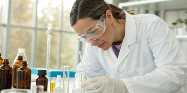 a scientist looking at a skincare product formulation in a lab