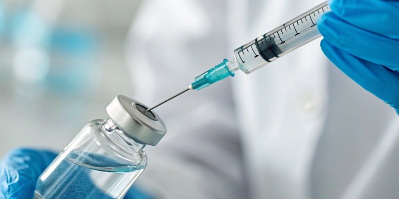 A close-up of a vaccine vial with a syringe, highlighting safety.